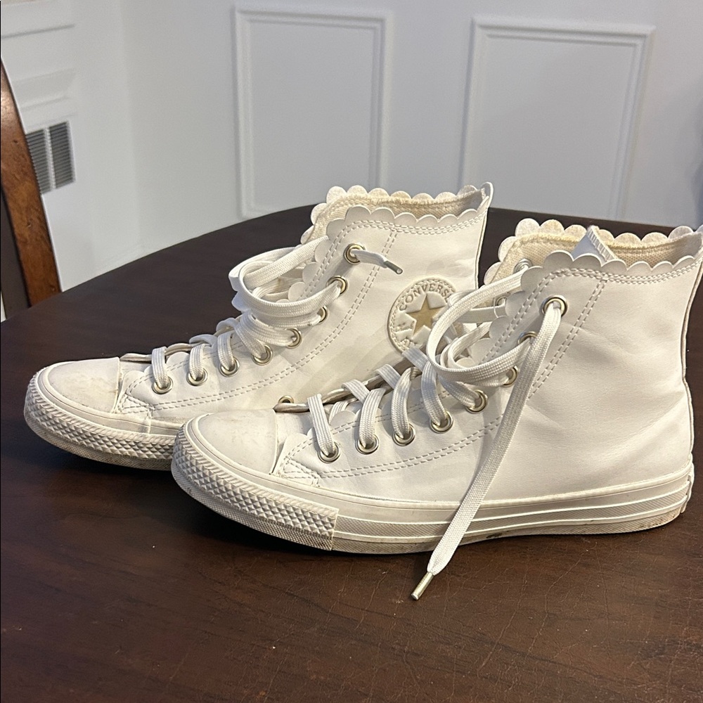 White converse high tops with cute scalloping on the edges.